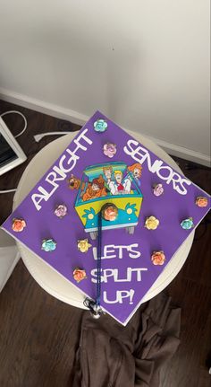 a purple and white graduation cap with the words,'let's split up'on it