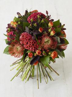 a bouquet of flowers sitting on top of a white table