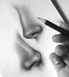 a woman's nose is shown with a pencil in her right hand and the other hand holding a pen