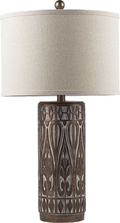 a table lamp with a white shade on it and a brown metal frame around the base