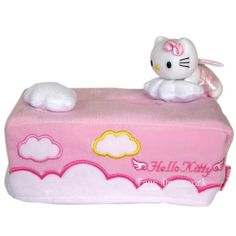 a hello kitty toy sitting on top of a pink box