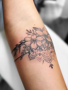 a woman's arm with flowers on it