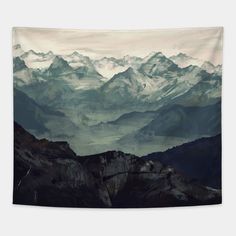 the mountains are covered with snow and clouds in this photo tapestry wall hanging art print