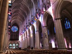 the inside of a large cathedral with stained glass windows