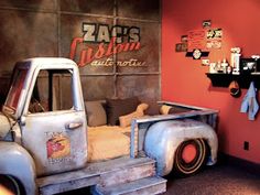 an old pick up truck bed is in the corner of a room with red walls