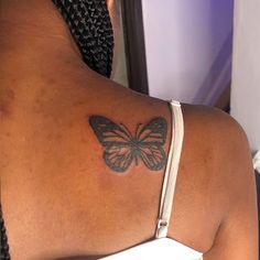 a woman with a butterfly tattoo on her arm