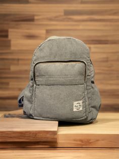 Introducing our stylish and sustainable Corduroy Backpack, available in four beautiful hues: green, deep blue, grey, and brown. Handmade in Nepal, this backpack is made from recycled corduroy fabric, making it an eco-friendly choice for conscious consumers. Dimensions: - Length: 16 inches - Width: 13 inches Crafted with attention to detail, this backpack offers both function and fashion. The interior is lined for added durability and features a separate zip pocket designed for laptops up to 14 inches in size. Safely carry your laptop with ease, knowing it's well-protected within this spacious compartment. In addition to the laptop pocket, there is also a smaller zip pocket, perfect for safely storing smaller items like chargers, cables, or accessories. Keep your essentials organized and ea Corduroy Standard Backpack, Corduroy Backpack For Everyday Use, Corduroy Standard Backpack For Everyday Use, Corduroy Travel Backpack, Everyday Corduroy Standard Backpack, Corduroy Everyday Backpack, Corduroy Backpack, Gift For Students, Backpack Gift