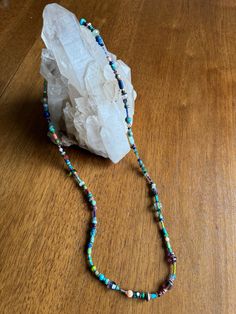 Immerse yourself in the rich tapestry of the Southwest with our Long Southwestern Beaded Necklace, a masterpiece meticulously crafted by George himself. This 28-inch necklace is a mesmerizing fusion of turquoise, coral, lapis, amethyst, agate, purple jasper, green quartz, pearls, and crystal, each gemstone chosen for its unique healing energies. Turquoise, the centerpiece of this exquisite piece, embodies the protective and soothing qualities of the Southwest. Coral infuses passion and vitality, Purple Jasper, Hippie Necklace, Green Quartz, Wearable Art, Crystal Beads, Fashion Statement, Hippie Boho, Necklace Lengths, Agate