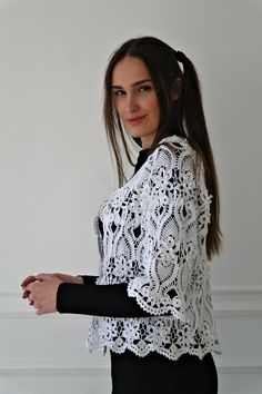 a woman in black and white is posing for the camera with her hand on her hip