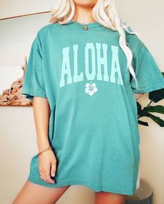 Please read description before purchasing. 100% cotton Comfort Color brand shirts. Distressed aloha tee with a hibiscus flower. Printed with water-based ink. Please note, for an oversized look, we suggest to size up 1-3 sizes depending on how oversized you would like it. These shirts run like standard unisex tees. Please see size chart. We are hooked on the soft vintage feel of Comfort Colors brand shirts and we know you will be too. Casual Hibiscus Print Tops With Relaxed Fit, Casual Relaxed Fit Tops With Hibiscus Print, Green Letter Print T-shirt For Vacation, Blue Hawaiian T-shirt Relaxed Fit, Blue Hawaiian T-shirt With Relaxed Fit, Green Hawaiian Tops With Hibiscus Print, Green Hibiscus Print Vacation Top, Green Hibiscus Print Top For Vacation, Hibiscus Print Graphic Tee With Short Sleeves