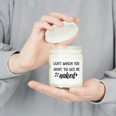 a person holding a jar with a white lid and black lettering that says wine bread candy wine