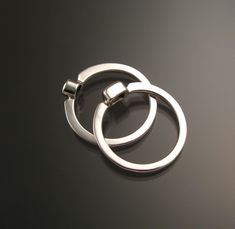 "Set of two Sterling Silver rings with your choice of premium natural birthstones.(restrictions apply). Size and shape can vary (triangle, round, oval, and square). Stones are between 3.5 and 4.5mm. Two rings are about 4mm wide at the bottom and 6mm at the top. Specify ring size and birthstone preference in a \"note to seller\" at check-out. It is always best to send me a note before ordering to work out the details." Modern Sterling Silver Stackable Rings Round Cut, Modern Oval White Gold Stackable Rings, Modern Sterling Silver Stackable Rings With Tension Setting, Modern Stackable Rings With Tension Setting For Gift, Modern Stackable Rings With Tension Setting As Gift, Modern Sterling Silver Solitaire Rings, Modern White Gold Ring With Birthstone, Modern Oval Stackable Rings With Polished Finish, Modern Sterling Silver Stackable Rings For Promise