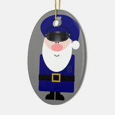 an oval ornament with a santa clause on it's face, hanging from a gold chain