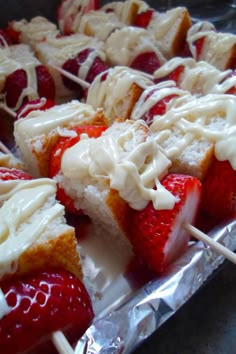 strawberry shortcakes with white icing and strawberries on top are ready to be eaten