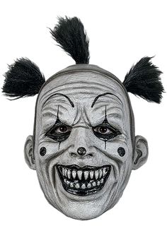 a creepy clown mask with black hair on it