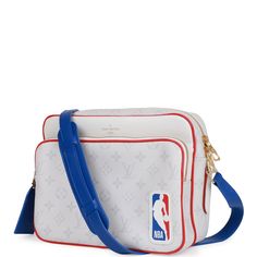 This limited edition LV x NBA Nil PM bag is of Antartica coated canvas with golden brass hardware and features the NBA logo, red leather trim, a zip closure, a removable leather luggage tag, back slip pocket and an adjustable blue leather strap. The interior is lined in blue fabric with two slip pockets in the main compartment. Origin: France Condition: Pristine; new or never Accompanied by: Louis Vuitton dustbag and luggage tag Measurements: 10.25' width x 7.75' height x 3.25' depth; 21.5' adjustable drop Leather Luggage Tag, Nba Logo, Leather Luggage Tags, Leather Luggage, Lv Bag, Luggage Tag, Luggage Tags, Blue Fabric, Blue Leather