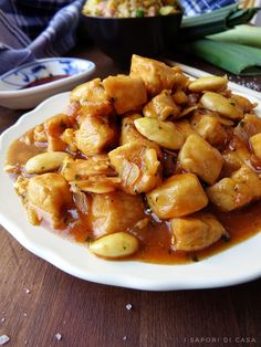 a white plate topped with fried food and chopsticks