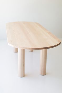 a wooden table sitting on top of a white floor