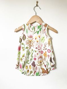 Your little will look super cool while staying cool in this bubble romper! So perfect for layering in cooler weather, and on it's own for hot summer days! This is sewn up in our beautiful flora & fauna print. This stylish bodysuit features cotton produced in the USA that is certified organic by global organic textile standards so you can feel good about dressing your baby in it! We serge all seams for added durability and strength. We include snaps for easy dressing and diapering. Here is ou Cute Floral Print Bubble Romper For Playtime, Cotton Floral Print Bubble Romper For Playwear, Casual Floral Print Bubble Romper For Playtime, Playful Cotton Onesie With Floral Print, Playful Cotton Floral Print Jumpsuits And Rompers, Playful Cotton Floral Print Jumpsuit, Summer Cotton Onesie With Floral Print, Summer Floral Print Bubble Romper For Playtime, Summer Bubble Romper For Spring Playdate