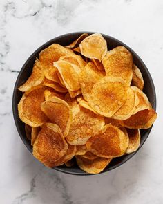 a white plate topped with sliced potato chips