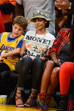 two children sitting next to each other at a basketball game