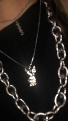 a woman wearing a black shirt and silver chain necklace