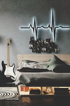 a bedroom with an electric guitar on the wall and a bed in front of it