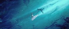 two people are swimming in the water with their surfboards