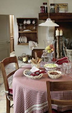 a dining room table with plates and bowls on it