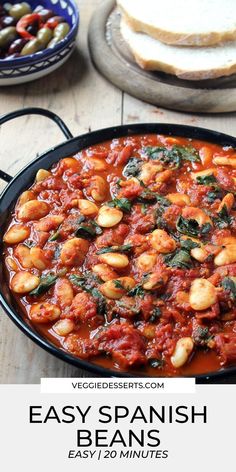 an easy spanish bean stew in a cast iron skillet with bread on the side