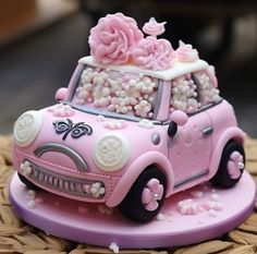 a pink car decorated with flowers and pearls