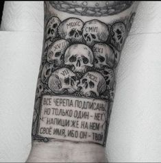 a man's arm with skulls on it and a sign that says, no one is