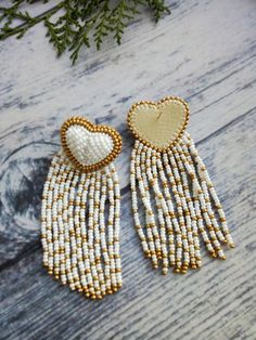 Fringed hearts for your lovely day or night! These earrings can also be a great gift idea. The earrings are light not heavy. Length:3.2 inch (8 cm) Gold Beaded Heart Earrings For Gift, Gold Beaded Dangle Heart Earrings, Heart-shaped Beaded Festive Jewelry, Heart Shaped Beaded Jewelry For Festive Occasion, White Bohemian Earrings With Heart Beads, Bohemian White Earrings With Heart Beads, Handmade Gold Beaded Earrings For Valentine's Day, Bohemian White Heart Beads Earrings, Festive Beaded Heart Jewelry