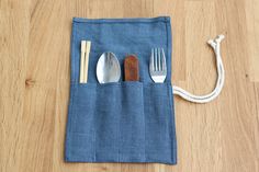 three spoons and two forks in a pouch