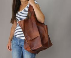 "Roomy leather shopping bag. Cognac brown oversized bag. Oversized bag - large leather tote bag. Large and stylish tote bag made from high quality leather. Spacious interior provides room for all the daily essentials and more. It is large enough to hold all your weekend essentials. This bag is perfect as your everyday bag, which can fit an IPAD, A4 files, books, magazines, cosmetic bag as well as many accessories. * Includes internal pockets for mobile phone and other small items. * Top closure Brown Tote Weekender Bag With Pockets, Brown Weekender Bag For Shopping, Brown Bucket Bag With Double Handle And Pockets, Brown Hobo Bag With Pockets For Shopping, Brown Leather Hobo Bag With Pockets, Brown Satchel With Pockets For Shopping, Large Leather Purse, Leather Work Bag, Slouchy Tote