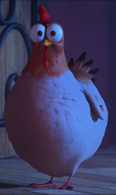 a chicken with big eyes standing on a wooden floor