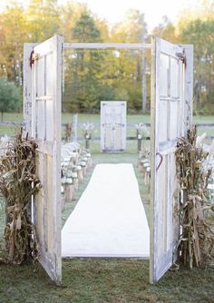 an open door leading to a ceremony with chairs in the background and flowers on the ground