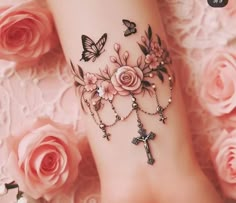 a close up of a person's foot with tattoos on it and roses in the background