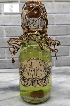 a green glass bottle with rope wrapped around it