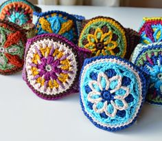 several crocheted balls are arranged on a table