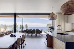 a large open kitchen and dining room with an ocean view