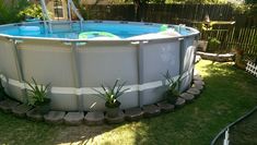 an above ground swimming pool in the backyard