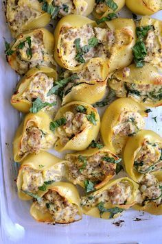 stuffed shells with meat and spinach in a casserole dish, ready to be eaten