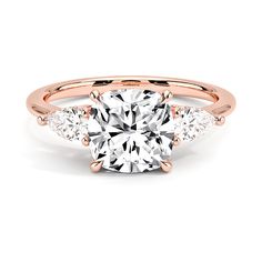 a rose gold engagement ring with an oval center stone and side stones on the band