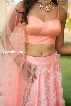 Peach bead embroidered skirt with peach bustier with pearl work and net dupatta with scallop embroidery (Skirt has cancan). Chaniya Choli