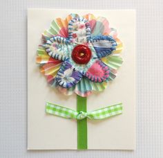 a card with a colorful flower on it