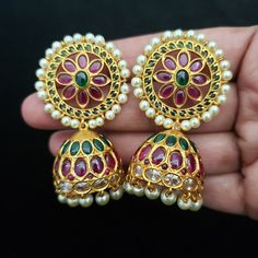 "These Jhumka Earrings set has an excellent finish and gives out an exquisite sense of style. If you are looking for an amazing Fashion Jewelry set for special occasions such as Anniversary, Engagement, Party, Wedding or for gifting, then your search ends here. Handmade Indian Temple Jewelry, best to wear it for traditional ceremonies or Indian wedding. This bridal jewelry has an ethnic finish. It has Cubic Zircon stones with ruby and emeralds. It is a Bollywood style one gram jewelry. There are Fusion Style Peacock Design Earrings For Wedding, Fusion Style Wedding Earrings With Peacock Design, Fusion Wedding Earrings With Peacock Design, Round Latkan Temple Jewelry Earrings, Temple Jewelry Style Round Latkans Earrings, Round Latkans Temple Jewelry Earrings, Intricate Temple Jewelry Style Pearl Earrings, Elegant Multicolor Peacock Design Jhumkas, Elegant Round Jhumkas With Peacock Design