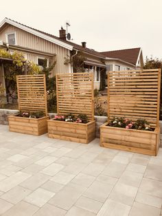 three wooden planters sitting on top of a patio