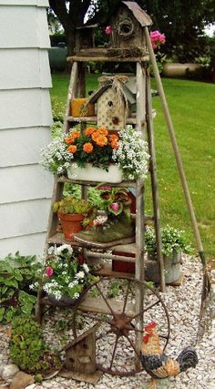 an old ladder is filled with potted flowers and other things to decorate it for the garden