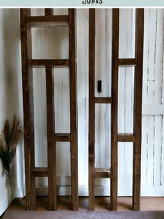 an open wooden door in front of a white wall